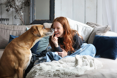 Lady cuddling dog