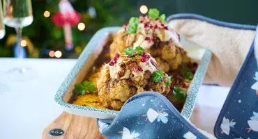 Whole Roasted Harissa Cauliflower with Hummus Dressing