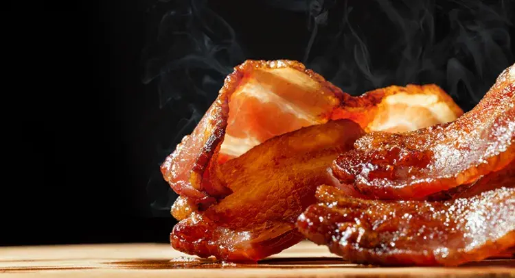 Hot streaky bacon with steam rising 